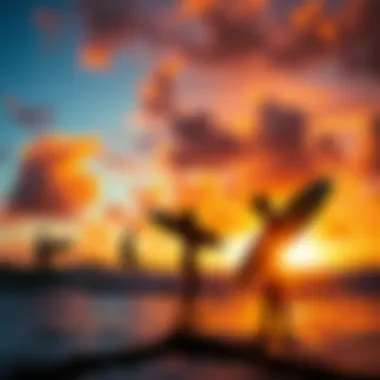 A vibrant sunset over the ocean with surfers creating silhouettes in the foreground.
