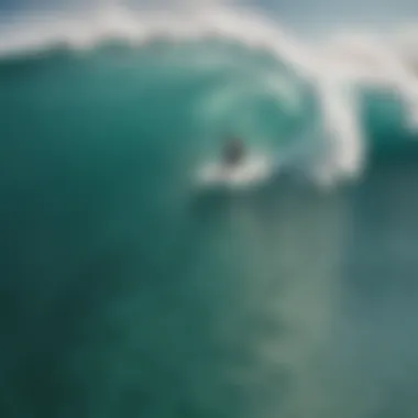 An aerial perspective of surfers riding the waves in the crystal-clear waters.