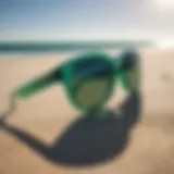 Emerald green sunglasses resting on a sunlit beach