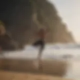 Surfer practicing yoga pose on the beach