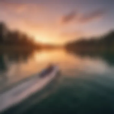 A serene sunset view of a lake with a boat and surfer in the distance