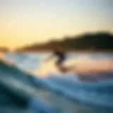 Skimboarder gliding along the shore