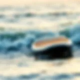 A sleek paddle board cutting through waves