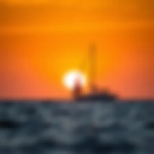 A serene sunset over the ocean with a sailboat silhouetted against the horizon
