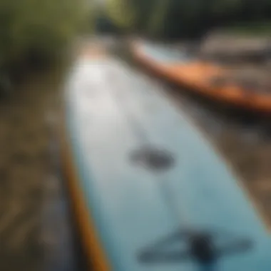 A close-up of paddleboarding gear including paddles and boards.