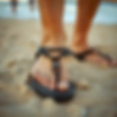Stylish Sanuk Black footwear on a sandy beach