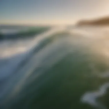 Close-up of surfboard with ocean waves in background