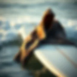 A stylish surf poncho towel draped over a surfboard