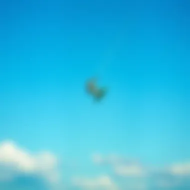 Aerial Acrobats: Kitesurfing at Its Finest A kitesurfer performing a jump against a clear blue sky