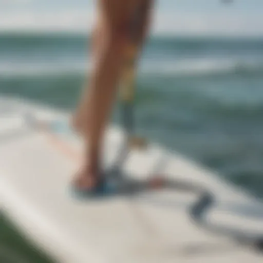 Close-up view of a calf leash attached to a surfboard