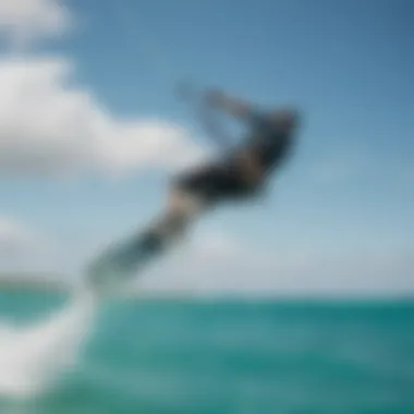 A kiteboarder executing a jump over turquoise waters