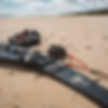 Kitesurfing equipment laid out on the sandy shore