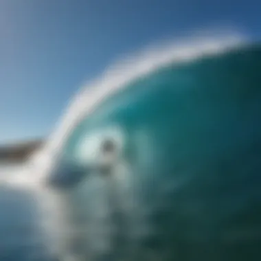 A surfer riding a perfect wave under a clear blue sky