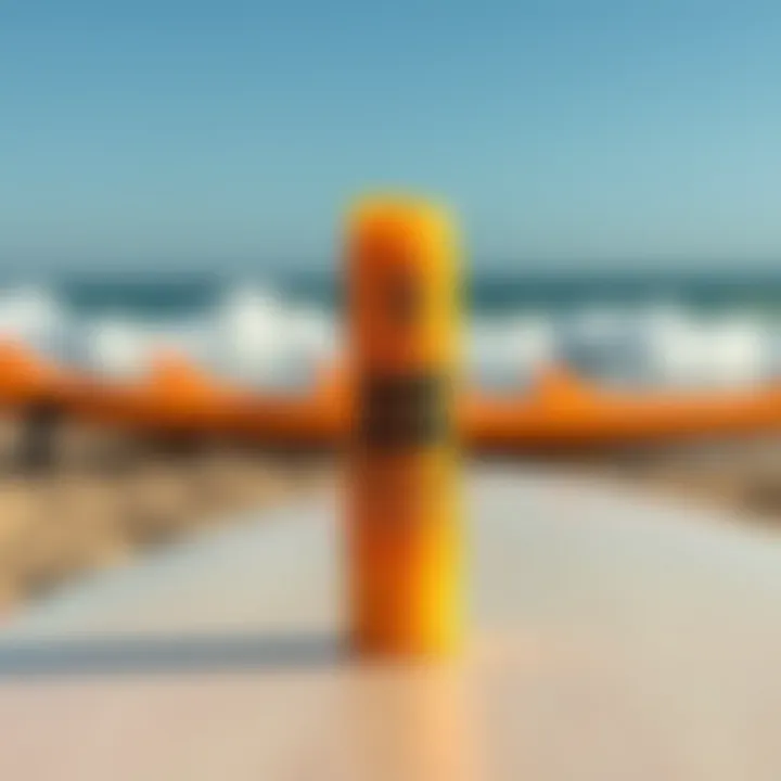 Sun Bum Mango Lip Balm placed on a surfboard against a beach backdrop
