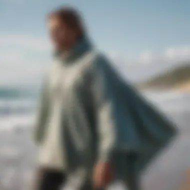 A surfer changing discreetly behind a surf poncho at the beach