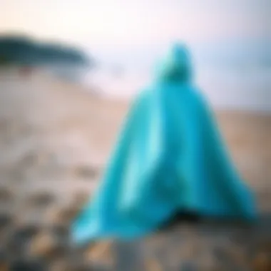 Versatile Towelling Poncho on the Beach A vibrant towelling poncho displayed on a sandy beach, showcasing its versatility and comfort.