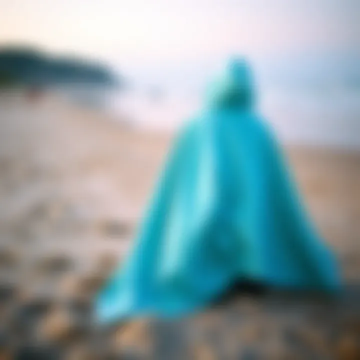 Versatile Towelling Poncho on the Beach A vibrant towelling poncho displayed on a sandy beach, showcasing its versatility and comfort.