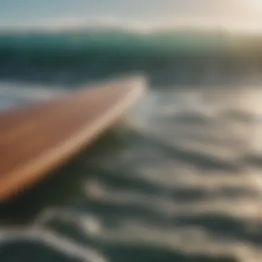 A close-up of a surfboard with ocean waves in the background