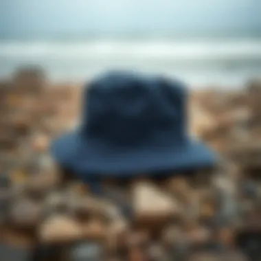 Navy boonie hat on a rocky beach setting