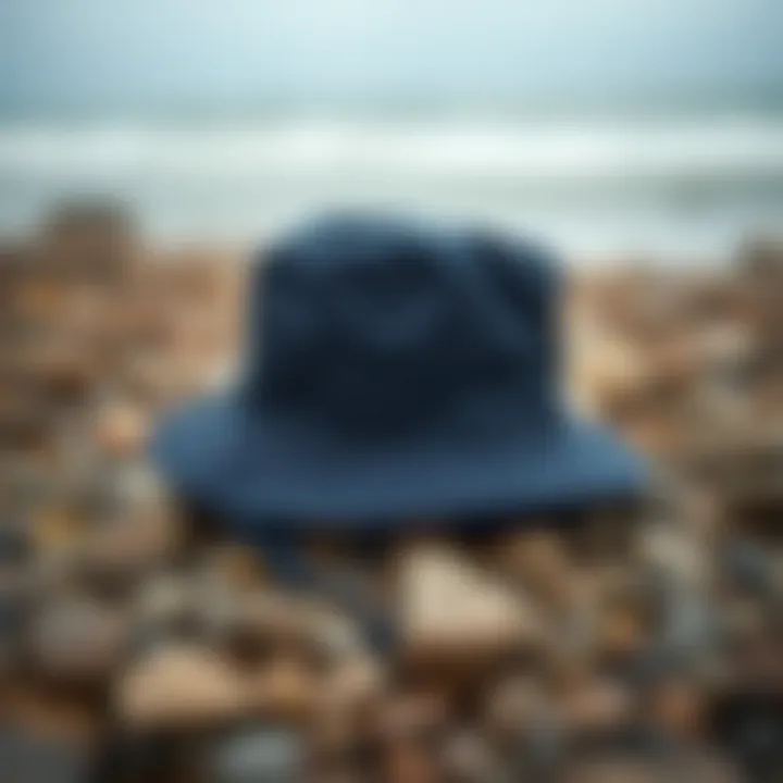Navy boonie hat on a rocky beach setting