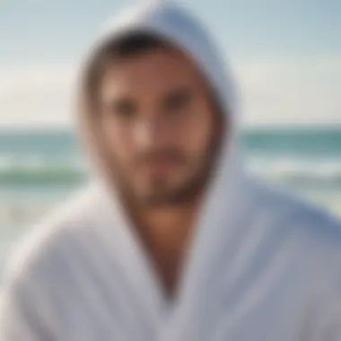 Man wearing a hooded towel after a swim in the ocean