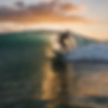 Surfer catching a wave at sunset on a popular Hawaiian beach