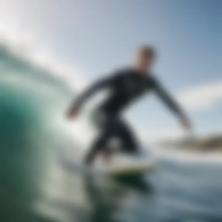 Surfer wearing the Volt wetsuit while catching a wave